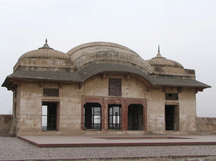 a building made of stone with arches and roof