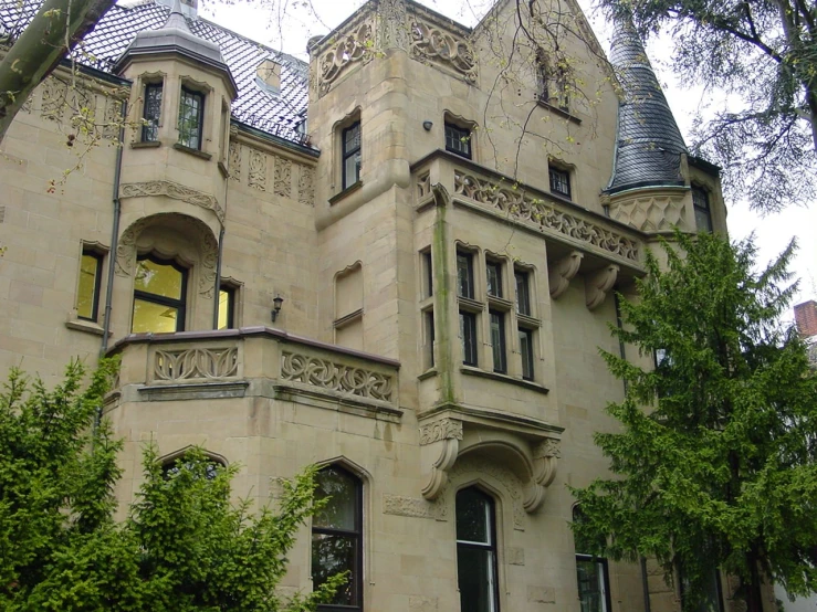 an old mansion in the middle of a tree lined area