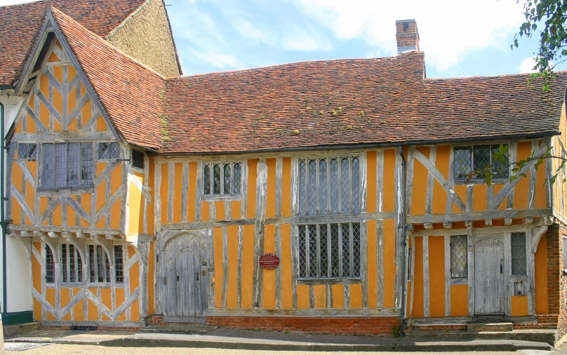 an old home with painted walls and a clock on the front