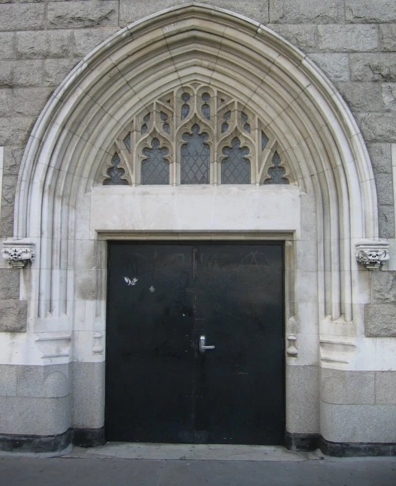 an arched doorway is in front of a stone building