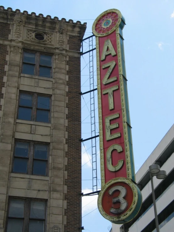 a tall building next to an old neon sign