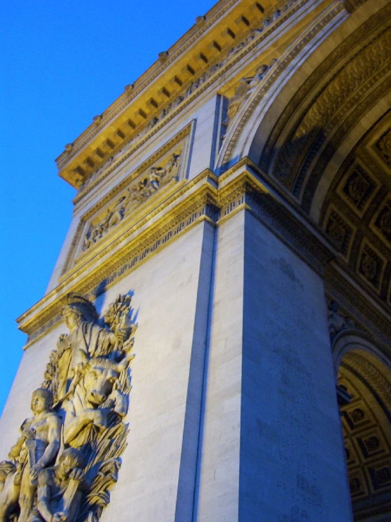 the entrance to a building that has some statues on it