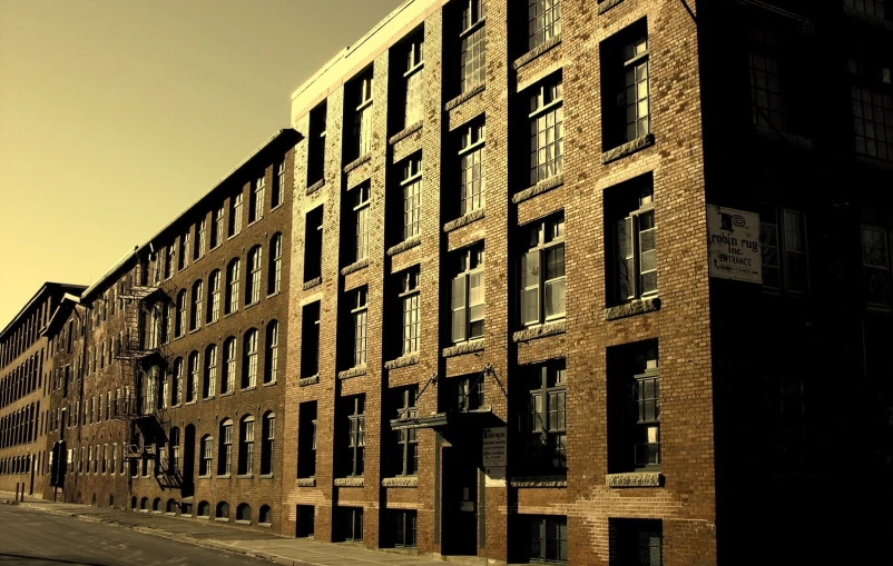 the side of an old brick building and its parking lot