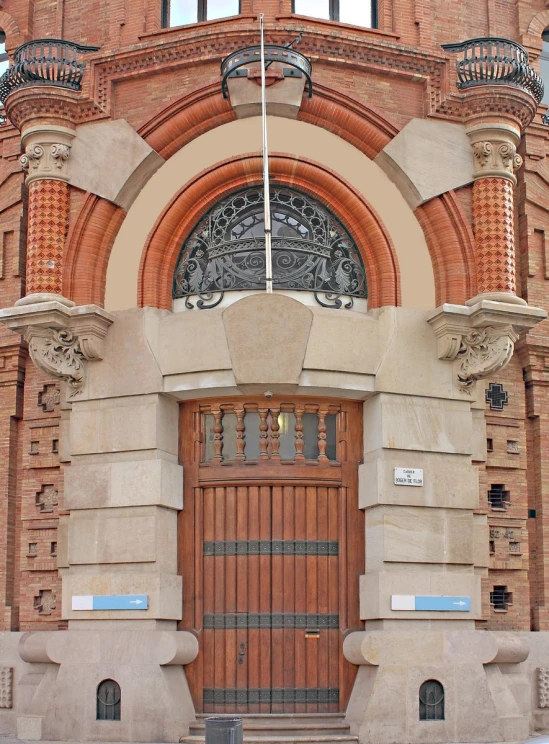 an old building that is red brick and has carvings on the front door