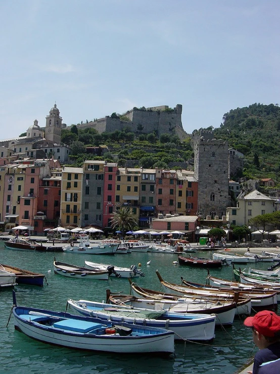 a number of boats in a body of water near a city