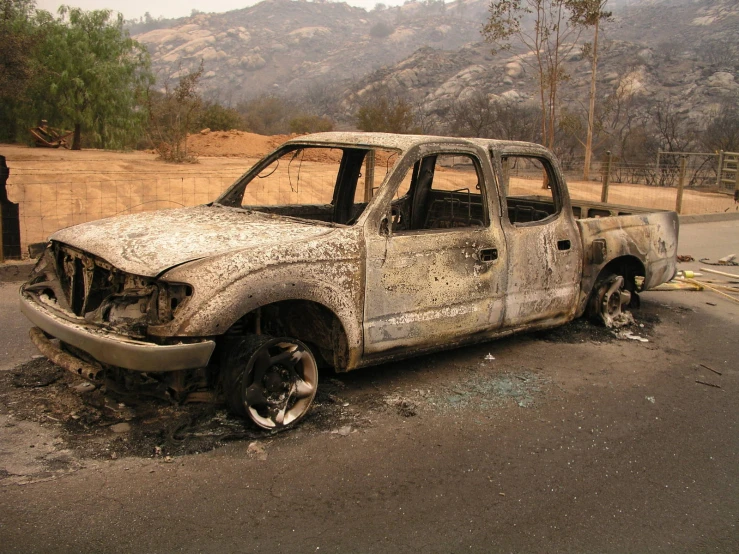 an old white pickup truck has been burnt to pieces