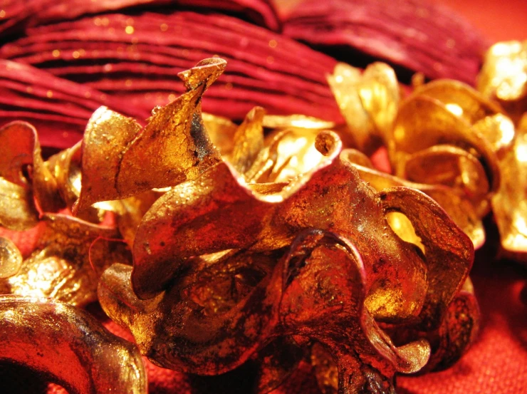 a red table cloth that has gold colored bows