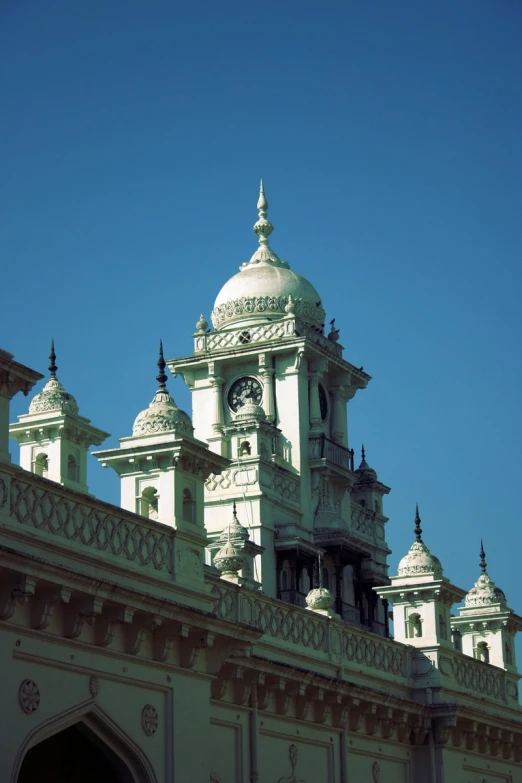 a tall white building with a clock on top