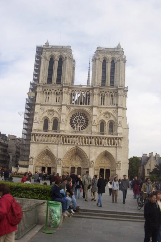 the giant church in paris has many people walking around