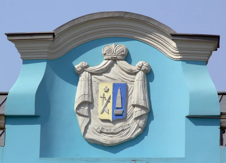 a picture of an emblem on a building with blue paint