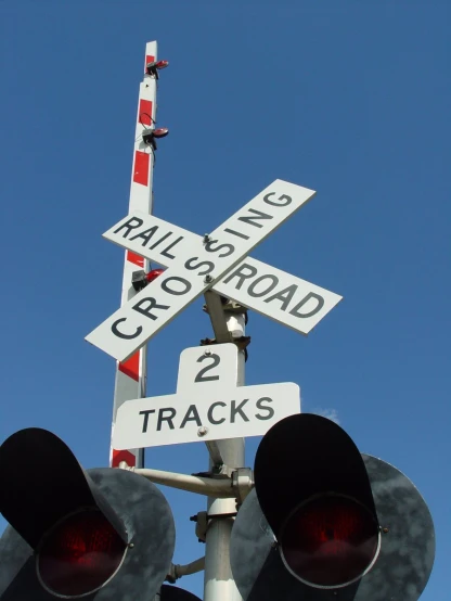 three railroad crossing signals on top of one another