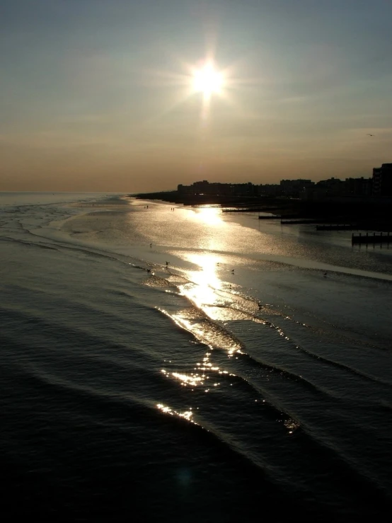 a boat is out on the ocean at sunset