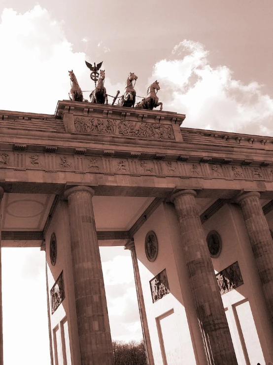 the entrance to an ancient building with sculptures on top