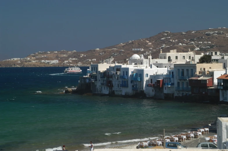 a long pier at the water's edge with houses on it