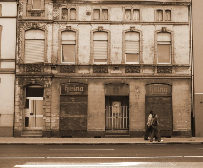 people walking in front of old buildings on a street