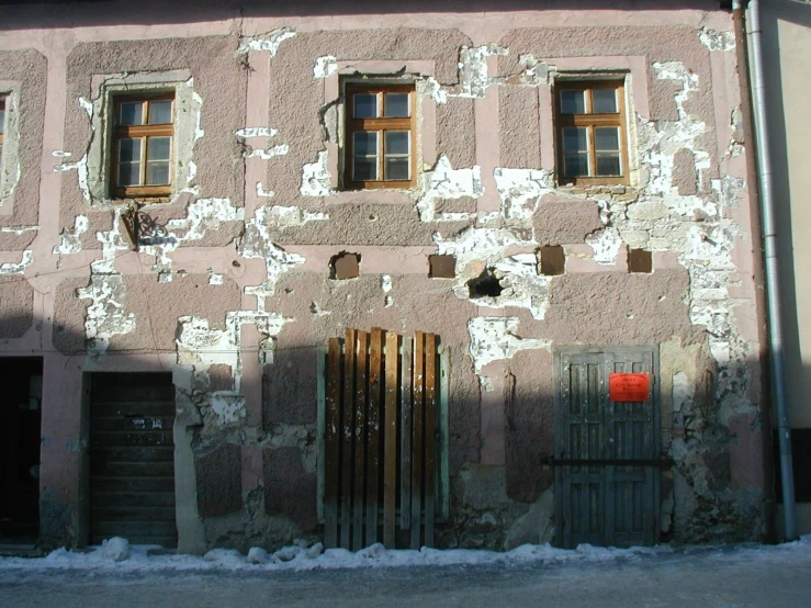 a stone building that has many windows and bars on it