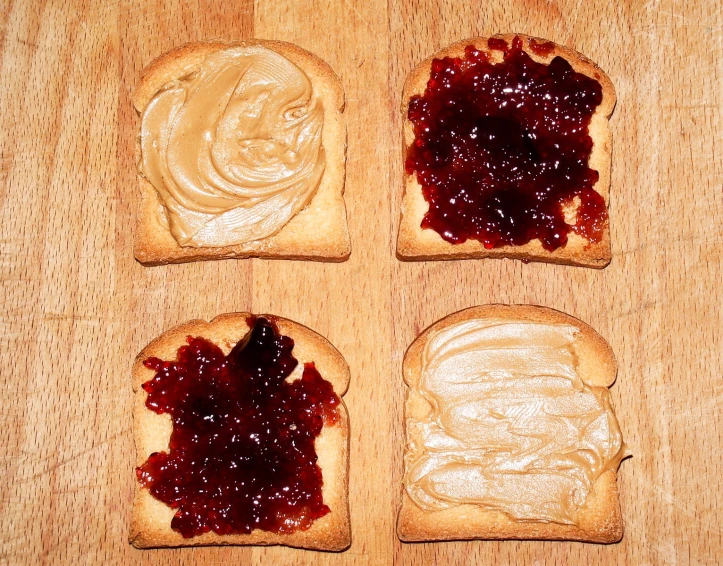 some peanut er and jelly toasts on a table