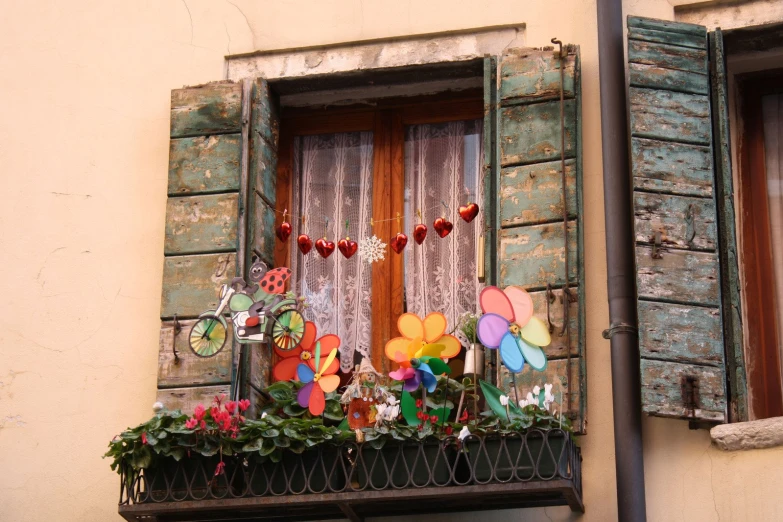 some colorful balloons in a window with other decorations