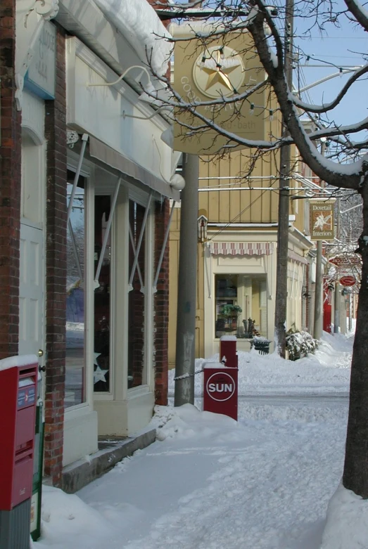 a street covered in snow with buildings and trees