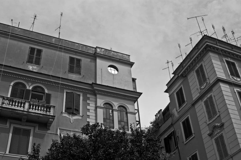 three buildings with windows and lights next to each other