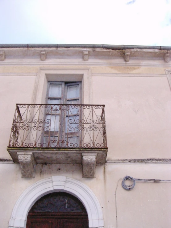 a large building with a balcony and a clock