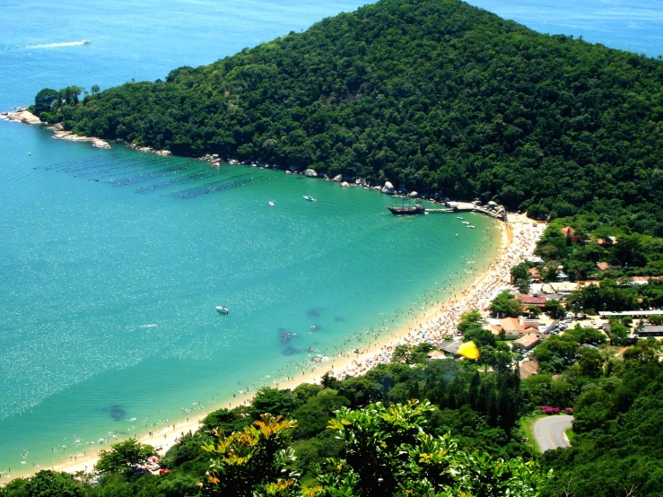 a sandy beach sits on the shore and on an island