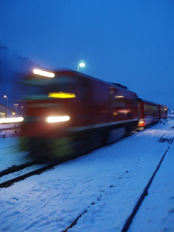 a train that is passing through some snow