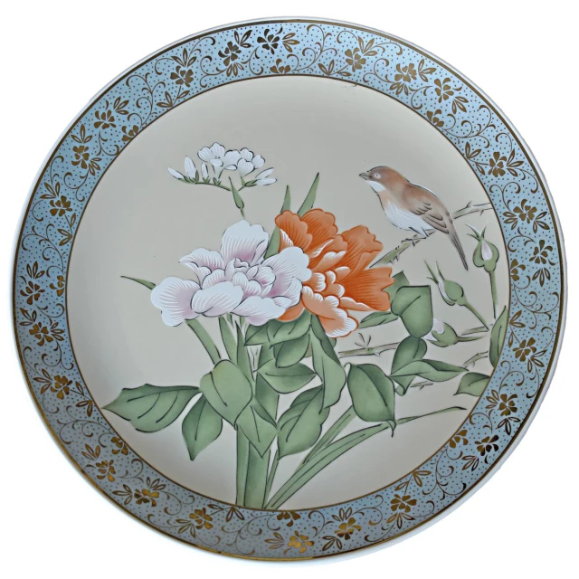 a white and blue floral plate with birds on the floral design