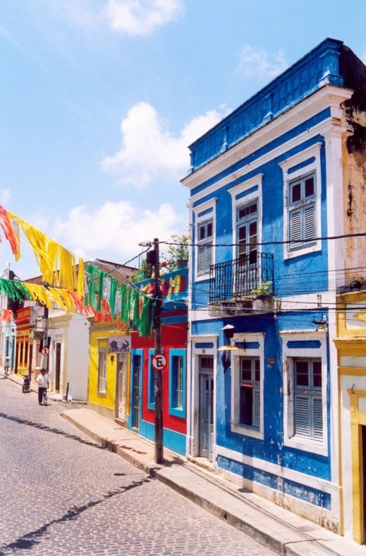 the colorful buildings are on the brick sidewalk