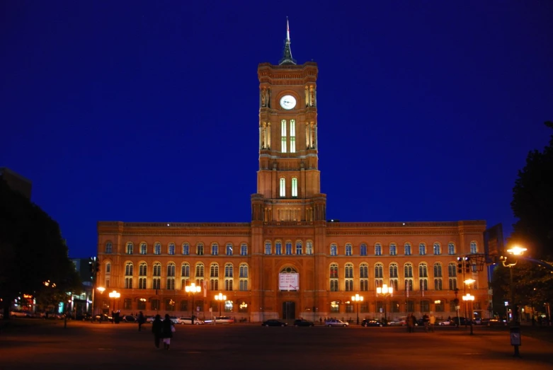 an historic building features a clock tower at night