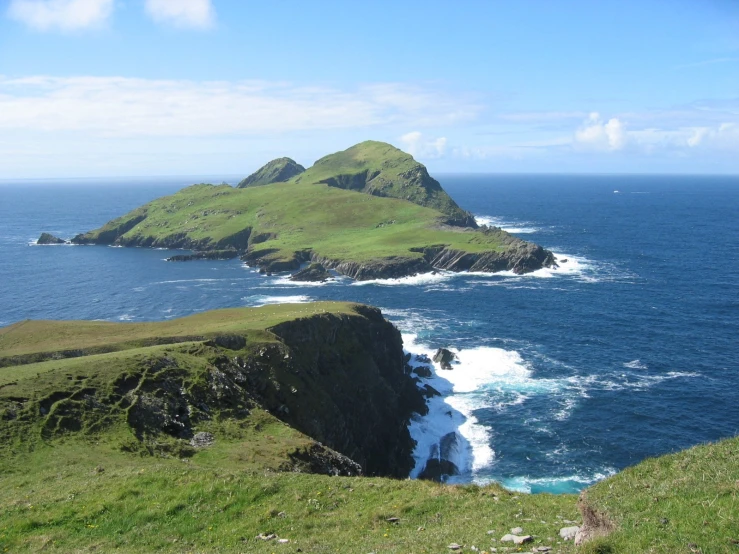 some very large grassy hills on the coast