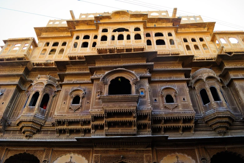 a tall and ornate building with several balconies on top