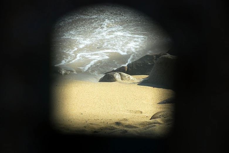 the view through a hole in a stone wall