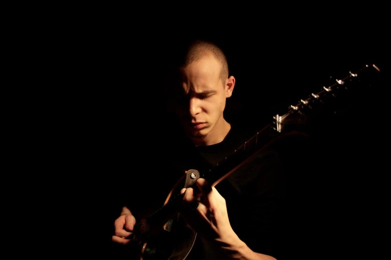 a man holding an electric guitar on stage