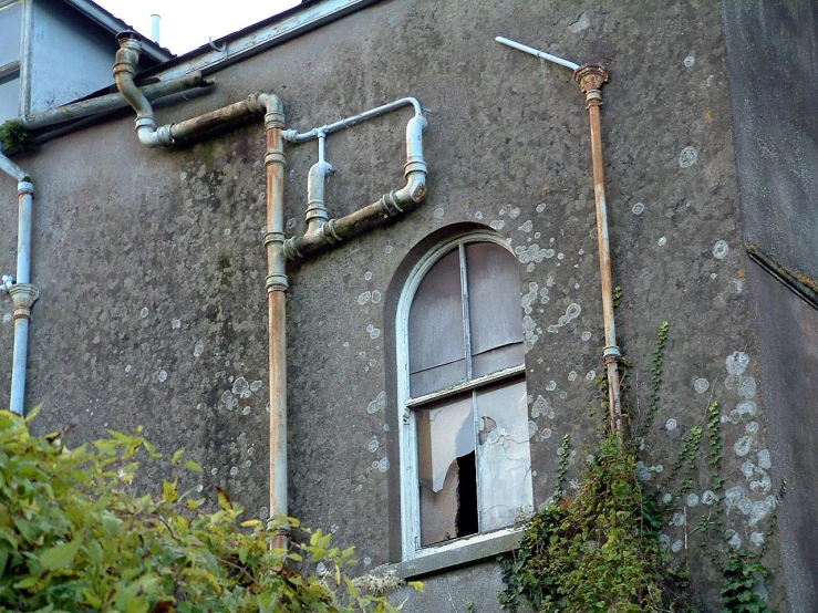 a large building with windows and pipes above it