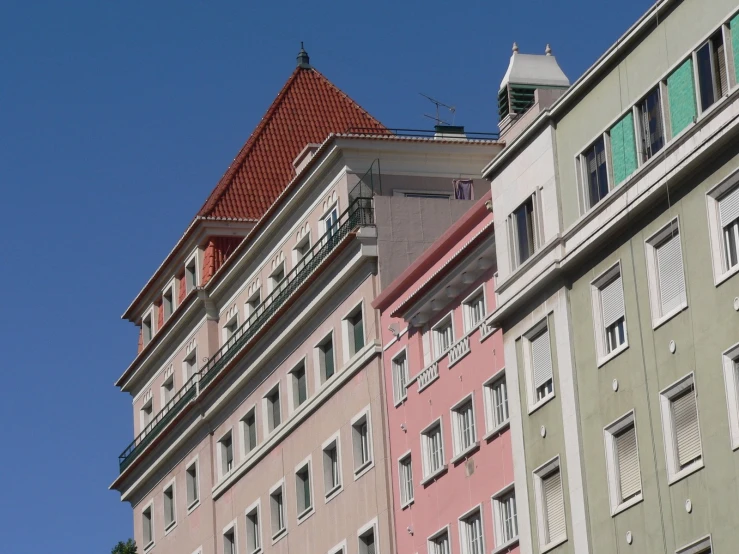 a couple of multi - colored buildings on a sunny day