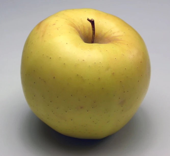 an apple is sitting on a white table