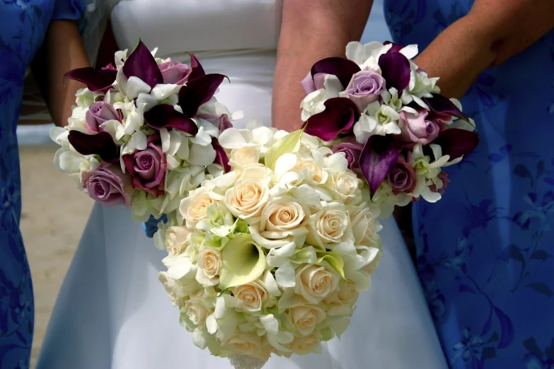 the bride's bouquet has a variety of colorful flowers in it