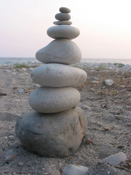 a stack of stacked rocks sitting on top of a beach