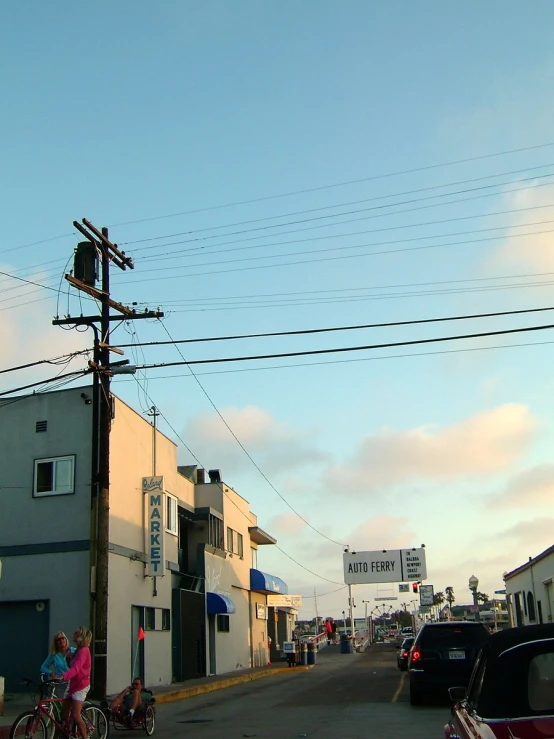 the sun shining on some businesses on the street