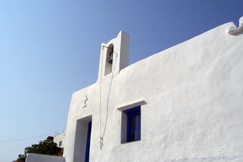 a church building with blue shutters is shown in white