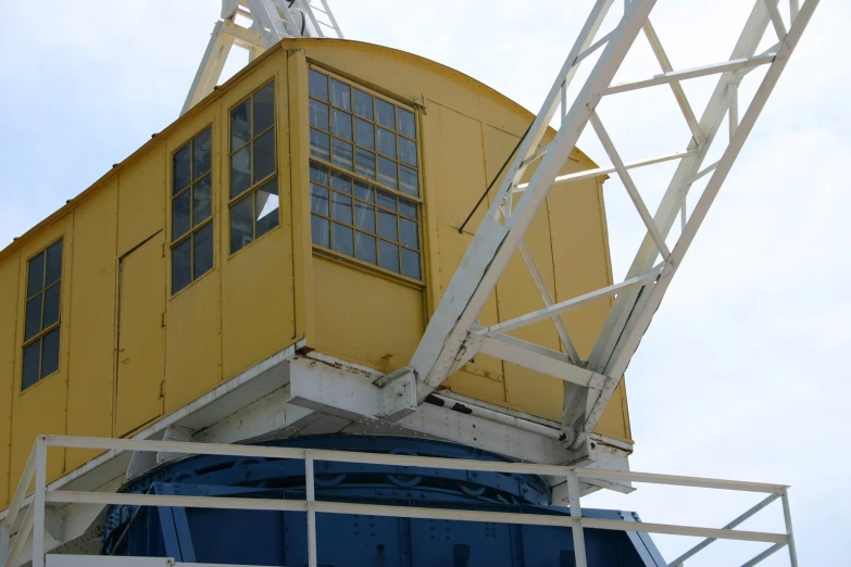 the upper part of a crane working on the side of a building