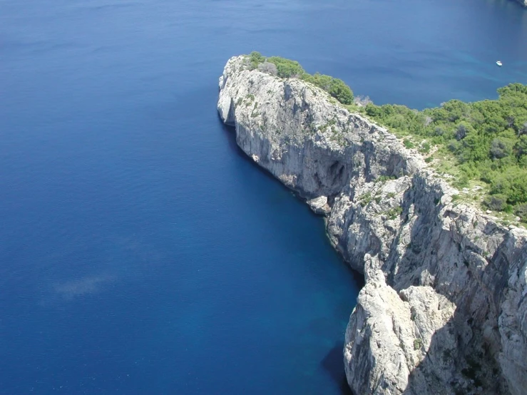 the rocky cliff ends to a beautiful blue ocean