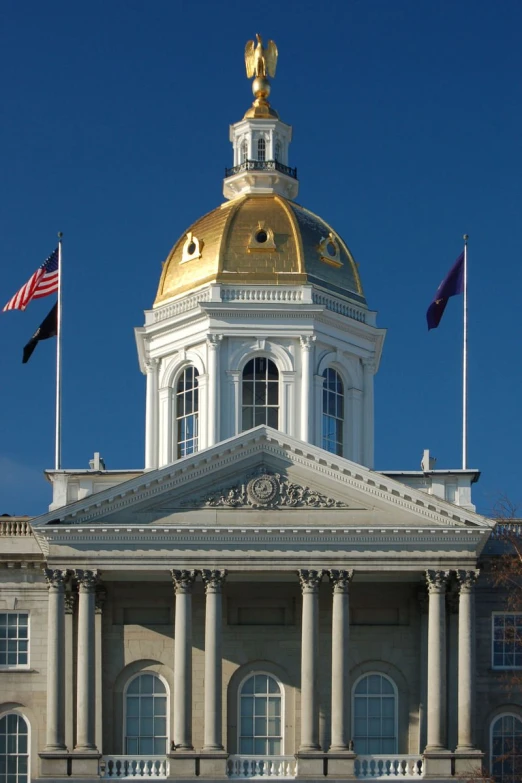 an old courthouse building is shown with a gold dome