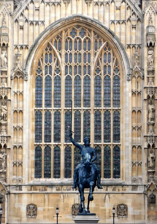 statue of man on horseback near an old building