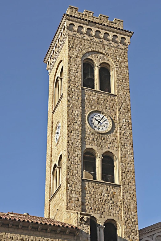 a tall building with a clock on each side