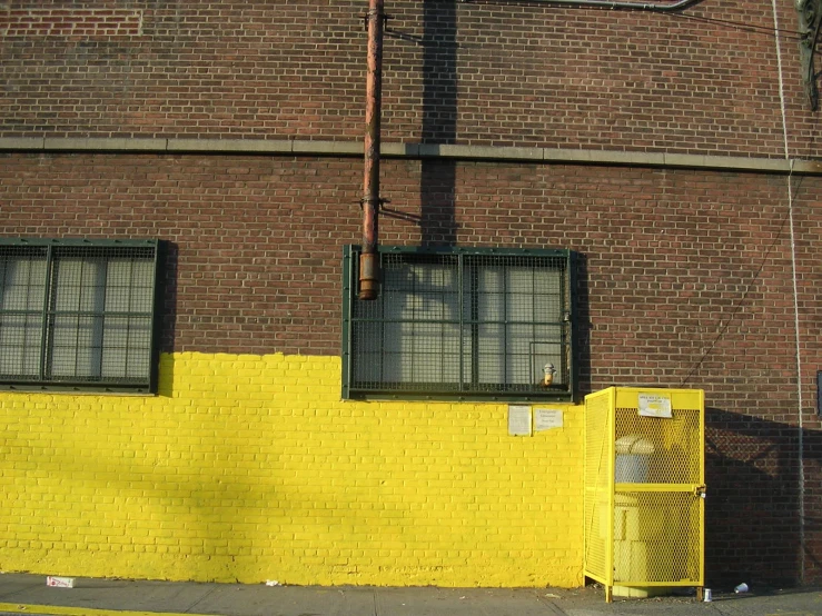 a stop sign on the side of a yellow building