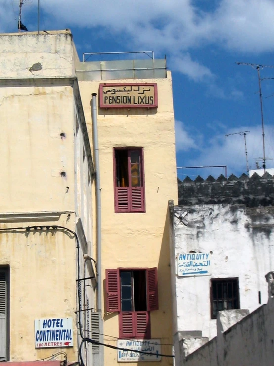 a building with windows on the top and a sign above it