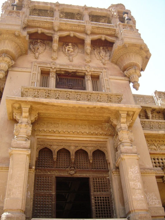 an ornate building is adorned with elaborately carved pillars