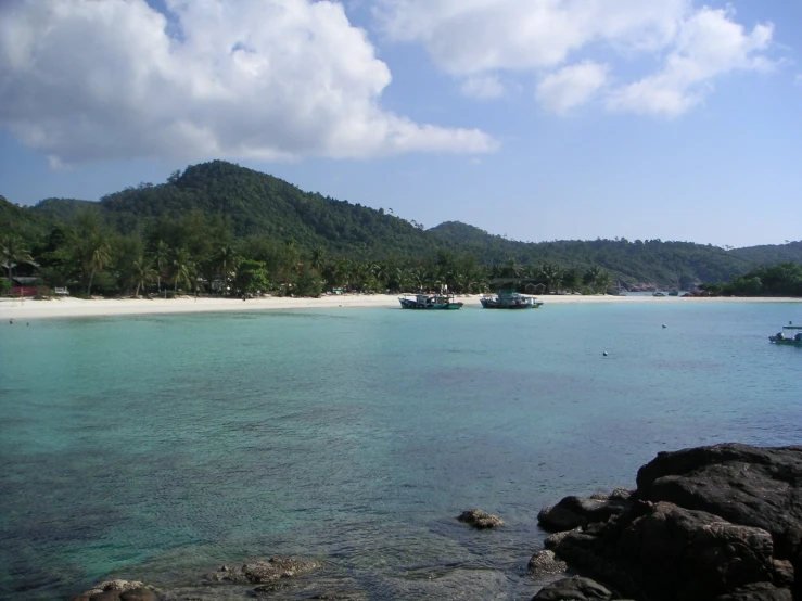 boats docked along an island on the ocean